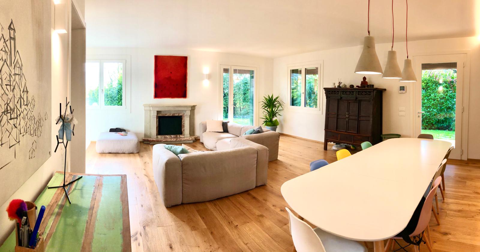 Soggiorno e sala da pranzo con parquet in rovere dopo la ristrutturazione